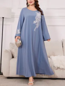 Abito lungo blu taglia forte a maniche lunghe con elegante ricamo argentato in ambiente indoor.