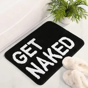 Tapis de bain noir antidérapant avec inscription blanche get naked pour salle de bain
