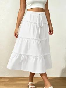 Detail shot of white tiered maxi skirt featuring elastic drawstring waist and elegant ruffle details.
