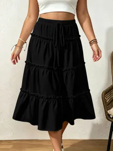 Black tiered midi skirt featuring an elastic drawstring waist and ruffle patchwork.