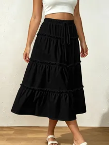 Detailed view of the black tiered midi skirt featuring an elastic drawstring waist and ruffles.