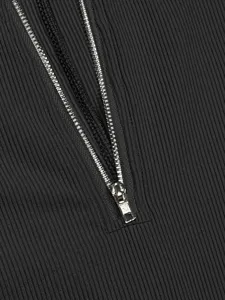 Close-up detail of silver metallic zipper and dark grey ribbed knit fabric texture.