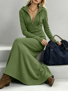 Detailed view of a stylish green ribbed hooded maxi dress featuring a chic half-zipper front.