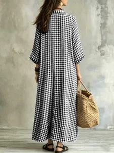 Back view detail of a black and white plaid maxi dress, loose fit with lantern sleeves.