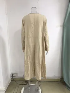 Back view detail of casual loose long sleeve bohemian maxi dress in solid beige color.