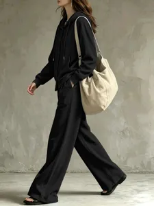 Casual black two-piece tracksuit with hoodie and wide-leg trousers for women autumn.