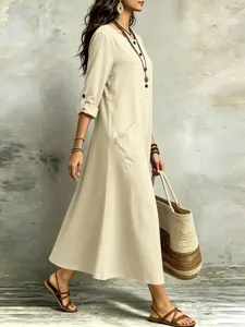 Close-up view of the casual bohemian midi dress featuring roll-up sleeves and utility pocket.