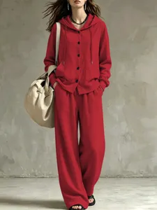 Detailed view of red hooded cardigan and wide-leg pants set, casual women outfit.