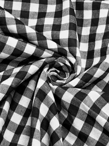 Close-up detail of classic black and white gingham checkered fabric texture, elegant and stylish