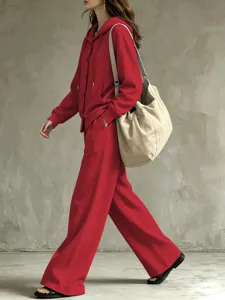 Detailed view of the red casual hooded cardigan and wide-leg trouser set, soft fabric.