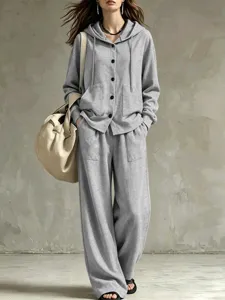 Detailed showcase of grey hooded cardigan and relaxed wide-leg pants set. Soft fabric.