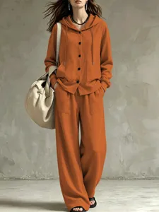 Casual orange hooded cardigan set detail showcasing drawstring hoodie and wide-leg trousers.