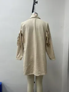 Detail shot of the back of a beige fringe long sleeve cardigan jacket with lapel design.