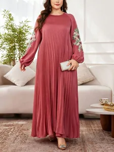 Elegant plus size pleated maxi dress featuring delicate floral embroidery on long sleeves.