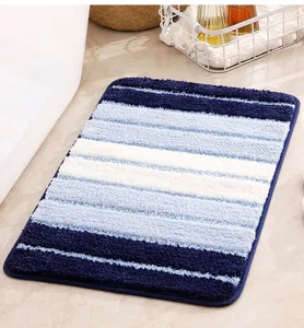 Soft blue and white striped bath mat with ultra absorbent plush surface for bathroom floor.