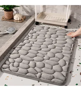 Grey memory foam bath mat with pebble embossed design, soft and anti-slip for bathroom.