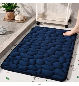 Close-up of soft blue pebble memory foam bath mat in cozy modern bathroom interior.