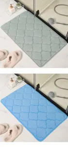 Thickened coral velvet bathroom mat with embossed design, soft and absorbent surface.