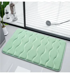 Detailed view of the soft memory foam bath mat in mint green with wave embossed non-slip design.