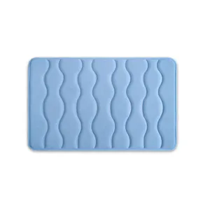 Blue memory foam bath mat with embossed wave pattern, anti-slip bathroom floor rug.