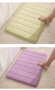 Detailed view of soft memory foam bath mat showing striped texture and water absorption.