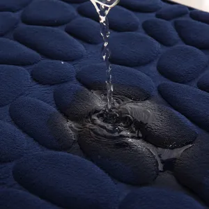 Non-slip memory foam bath mat with pebble design, dark blue absorbent floor rug for bathroom.