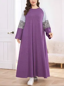 Plus size long sleeve maxi dress featuring contrast striped and leopard print sleeves.