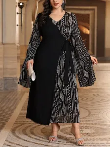 Dettaglio dell'abito lungo elegante con maniche lunghe, motivo geometrico e stile a portafoglio.