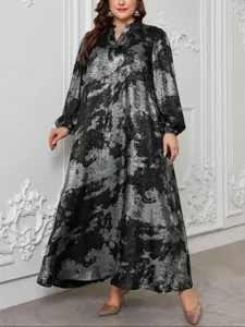 Detailed view of the elegant plus size long sleeve maxi dress in black and silver print.