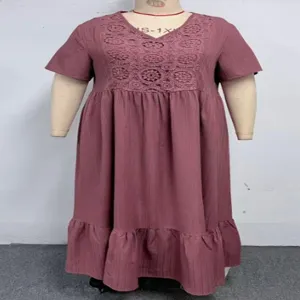 Detailed view of plus-size lace patchwork dress, showcasing short sleeves and ruffled hem.