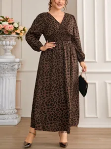 Plus size brown leopard print maxi dress with long sleeves, V-neck, and smocked waist design for women.