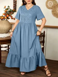 Detailed view of the blue lace patchwork dress showcasing V-neck and stylish ruffle hem in home.