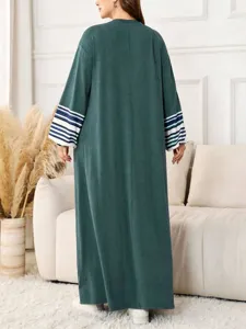 Detail view of a women's dark green loose long robe featuring contrast striped sleeves.