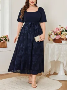 Details of elegant navy blue plus-size midi dress with square neck and floral jacquard pattern.