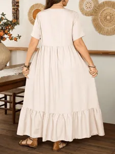 Back view detail of casual loose beige maxi dress with ruffled hem and short sleeves.