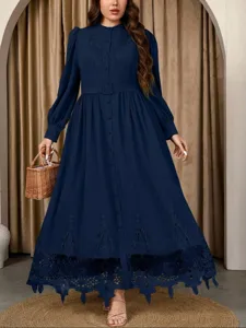 Elegant dark blue plus-size maxi dress with delicate embroidery, long sleeves, and chic belt.