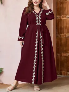 Plus size burgundy maxi dress with delicate floral embroidery details and elegant waist belt.