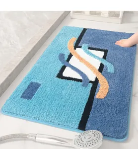 Thickened absorbent bathroom door mat with blue geometric tufted design for anti-slip use.