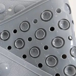 Non-slip shower mat with suction cups and drain holes for bathroom safety and comfort.
