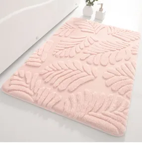 Close-up of fluffy pink bathroom mat featuring embossed leaf texture in a clean setting.