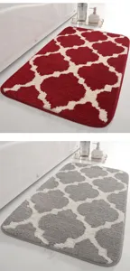 Detail shot of absorbent bathroom mat with geometric quatrefoil pattern in red and grey options.
