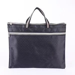 Detailed view of black oxford fabric document bag featuring honeycomb pattern and dual zippers.