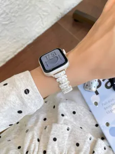 Stylish studded metal watch strap compatible with Apple Watch series, elegant and durable piece.