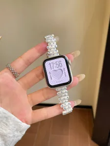Replacement metal watch band compatible with Apple Watch, stylish white studded strap design.