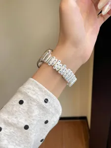 White ceramic watch band detail view featuring sparkling blue crystal rhinestones for Apple Watch.