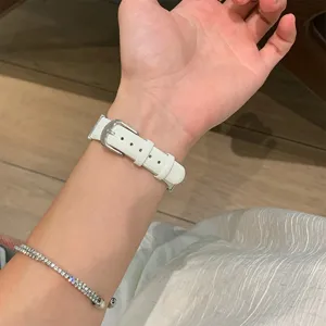 Close-up detail of white leather watch strap buckle replacement for smart watch wear.
