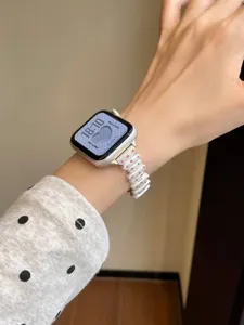 Close-up detail of irregular metal watch band with pink crystals compatible with Apple Watch.