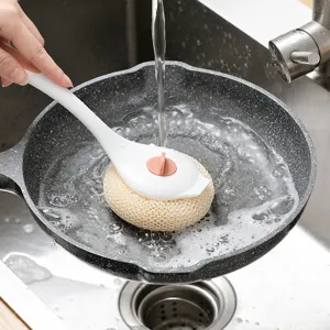 Long handle cleaning brush with sponge head for washing dishes and pots in kitchen sink.