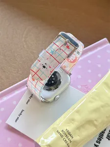 Detail view of cute cartoon bear silicone watch strap with stylish grid pattern for smart watch.