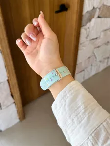 Cute polka dot silicone watch strap detail shot, soft material compatible with smart watch.